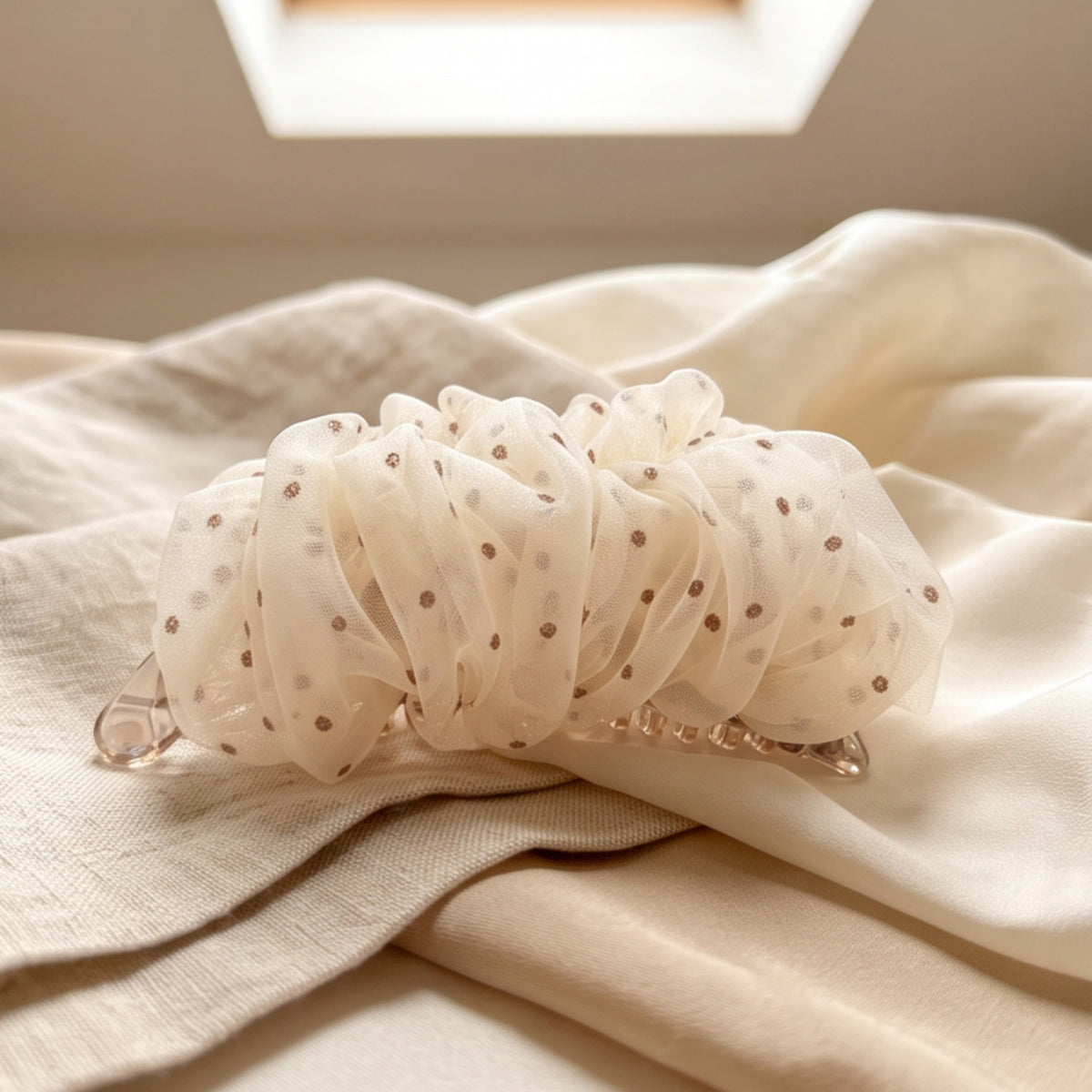 Brown polka-dot mesh banana hair clip styled flat lay