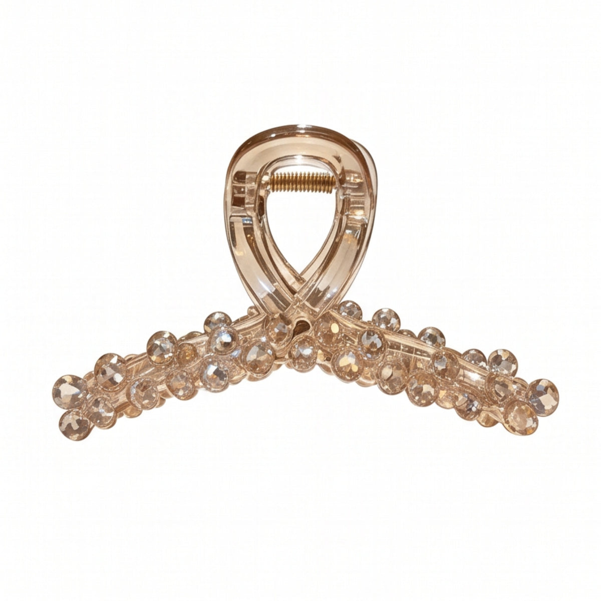 A translucent champagne-colored hair claw clip embellished with clear rhinestones along the curved bar, shown on a plain white background.