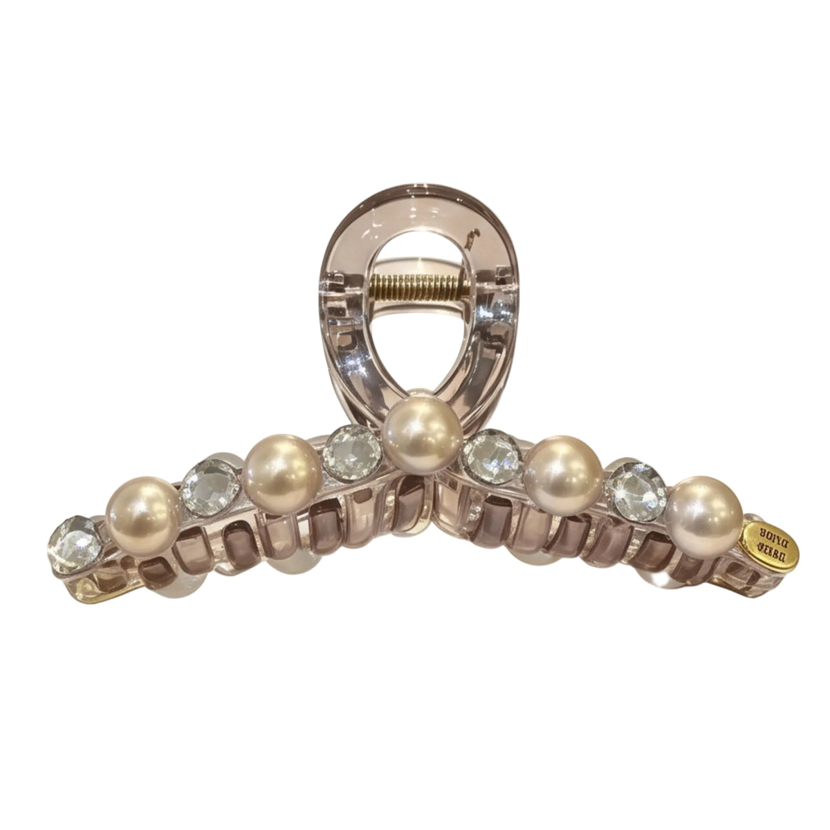A clear resin claw hair clip embellished with faux pearls and clear rhinestones, displayed on a reflective white surface.